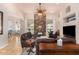 Spacious living room featuring a stone fireplace, ceiling fan, and leather furniture for comfortable living at 18226 W Marshall Ct, Litchfield Park, AZ 85340