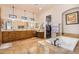 Luxury main bathroom with a soaking tub, dual sinks, and a walk-in closet at 18226 W Marshall Ct, Litchfield Park, AZ 85340
