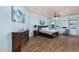 A spacious main bedroom featuring wood floors, blue walls, and comfortable furnishings at 18226 W Marshall Ct, Litchfield Park, AZ 85340