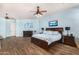 A spacious main bedroom featuring wood floors, blue walls, and comfortable furnishings at 18226 W Marshall Ct, Litchfield Park, AZ 85340
