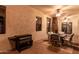 Covered patio with stone fireplace, ceiling fans, and outdoor dining set at 18226 W Marshall Ct, Litchfield Park, AZ 85340