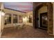 Cozy covered patio featuring tile flooring, a stone archway, and comfortable seating at 18226 W Marshall Ct, Litchfield Park, AZ 85340