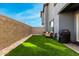Private backyard with artificial turf, block fencing, and an outdoor seating area at 1829 N 43Rd Ter, Phoenix, AZ 85008