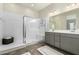 Modern bathroom featuring a large shower with a white bench and gray vanity at 1829 N 43Rd Ter, Phoenix, AZ 85008
