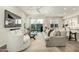 Cozy living room with a gray sofa, white armchair, and sliding glass doors to the backyard at 1829 N 43Rd Ter, Phoenix, AZ 85008
