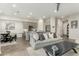 Bright living room with modern gray sofa, open floor plan, and tile flooring at 1829 N 43Rd Ter, Phoenix, AZ 85008