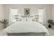 Bright main bedroom featuring white linens, white walls, and bedside lamps at 1829 N 43Rd Ter, Phoenix, AZ 85008