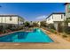 Community pool featuring crystal blue water, bordered by lounge chairs and landscaped grounds between modern townhome buildings at 1829 N 43Rd Ter, Phoenix, AZ 85008