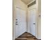 Clean entryway featuring two white doors, dark wood floors, and a neutral color scheme at 18416 N Cave Creek Rd # 3034, Phoenix, AZ 85032