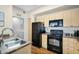 Well-lit kitchen with light wood cabinets and black appliances at 18416 N Cave Creek Rd # 3034, Phoenix, AZ 85032