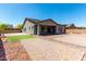 Expansive backyard featuring a covered patio, desert landscaping, and a brick-paved entertaining area at 18508 W Galveston St, Goodyear, AZ 85338