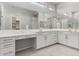 En Suite bath features dual vanities and makeup area with lots of countertop space and natural light at 18508 W Galveston St, Goodyear, AZ 85338