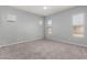 Bright bedroom with plush carpet, a modern ceiling fan, and large windows at 18508 W Galveston St, Goodyear, AZ 85338