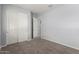 Bright bedroom featuring neutral walls, plush carpeting, and a double door closet for storage at 18508 W Galveston St, Goodyear, AZ 85338
