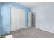 Inviting two-tone bedroom featuring neutral carpeting, closet and fresh walls at 18508 W Galveston St, Goodyear, AZ 85338