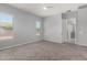 Spacious bedroom offers plush carpet, a modern ceiling fan, and lots of natural light at 18508 W Galveston St, Goodyear, AZ 85338
