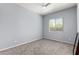 Spacious bedroom featuring neutral walls, plush carpeting, a window and modern fan at 18508 W Galveston St, Goodyear, AZ 85338