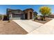 Beautiful single Gathering home boasting a stone entry way, desert landscaping, and a two car garage at 18508 W Galveston St, Goodyear, AZ 85338