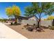 A sideways view of desert landscaping, trees, and a well maintained home at 18508 W Galveston St, Goodyear, AZ 85338
