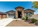 Charming single-story home featuring a stone entryway, a two car garage, and low maintenance landscaping at 18508 W Galveston St, Goodyear, AZ 85338