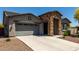 Inviting single-Gathering home with a stone accent entry, well-maintained landscaping, and a two-car garage at 18508 W Galveston St, Goodyear, AZ 85338