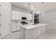 Contemporary kitchen with white cabinetry, stainless appliances, quartz countertops, and island with pendant lighting at 18508 W Galveston St, Goodyear, AZ 85338