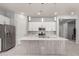 Modern kitchen with a large central island, stainless steel appliances, and stylish pendant lighting at 18508 W Galveston St, Goodyear, AZ 85338