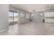 Open living room with tile floors, recessed lighting, modern ceiling fan, and sliding door to backyard at 18508 W Galveston St, Goodyear, AZ 85338