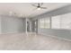 Spacious living room offers tile floors, recessed lights, a modern ceiling fan, and lots of natural light at 18508 W Galveston St, Goodyear, AZ 85338