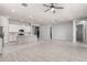 Bright and spacious open-concept living area with neutral tile flooring and a seamless flow to the kitchen at 18508 W Galveston St, Goodyear, AZ 85338