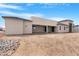 Backyard view of the house featuring a patio and desert landscaping at 19622 W Pasadena Ave, Litchfield Park, AZ 85340