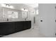 Modern bathroom features granite countertop vanity with black cabinetry and a stylish glass-enclosed shower at 19622 W Pasadena Ave, Litchfield Park, AZ 85340