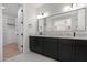 Modern bathroom featuring a double vanity with granite countertops and sleek black fixtures at 19622 W Pasadena Ave, Litchfield Park, AZ 85340
