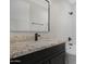 A stylish bathroom with modern fixtures and a granite countertop at 19622 W Pasadena Ave, Litchfield Park, AZ 85340