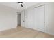 Bedroom featuring light wood floors, a ceiling fan, and a closet with sliding doors at 19622 W Pasadena Ave, Litchfield Park, AZ 85340