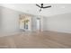 Spacious bedroom featuring light wood floors, a ceiling fan, and sliding glass door to the patio at 19622 W Pasadena Ave, Litchfield Park, AZ 85340