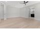 Large bedroom featuring light wood floors, a ceiling fan, and an ensuite bathroom at 19622 W Pasadena Ave, Litchfield Park, AZ 85340