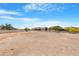 Expansive view of an empty lot with desert landscaping in the backyard at 19622 W Pasadena Ave, Litchfield Park, AZ 85340