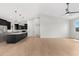 Bright and open living room showcasing hardwood floors seamlessly connecting to the kitchen area at 19622 W Pasadena Ave, Litchfield Park, AZ 85340