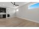 Spacious living room with hardwood floors, a ceiling fan, and bright windows at 19622 W Pasadena Ave, Litchfield Park, AZ 85340