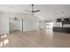 Bright and spacious living room with hardwood floors, high ceilings, and an open layout that connects to the kitchen at 19622 W Pasadena Ave, Litchfield Park, AZ 85340