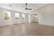 Bright living room with plenty of natural light from three windows with hardwood flooring and a ceiling fan at 19622 W Pasadena Ave, Litchfield Park, AZ 85340
