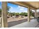 Covered patio overlooking a low-maintenance backyard with desert landscaping and a fenced perimeter at 20140 N 269Th Dr, Buckeye, AZ 85396