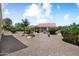 Spacious backyard with desert landscaping, mature trees, and a black metal fence at 20140 N 269Th Dr, Buckeye, AZ 85396