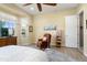 Bright bedroom featuring a cozy reading nook with a leather chair and a large window at 20140 N 269Th Dr, Buckeye, AZ 85396
