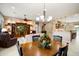 Dining area with a view into the living room and kitchen with an elegant chandelier at 20140 N 269Th Dr, Buckeye, AZ 85396