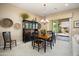 Dining room featuring a wooden table set, sleek cabinetry, and sliding glass doors to the backyard at 20140 N 269Th Dr, Buckeye, AZ 85396