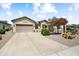 Charming home featuring a two-car garage, desert landscaping, and ample driveway space at 20140 N 269Th Dr, Buckeye, AZ 85396