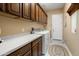 Laundry room with front-loading washer and dryer, counter space, and cabinetry at 20140 N 269Th Dr, Buckeye, AZ 85396