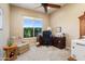 Home office with a large window, desk setup, and comfortable seating area at 20140 N 269Th Dr, Buckeye, AZ 85396
